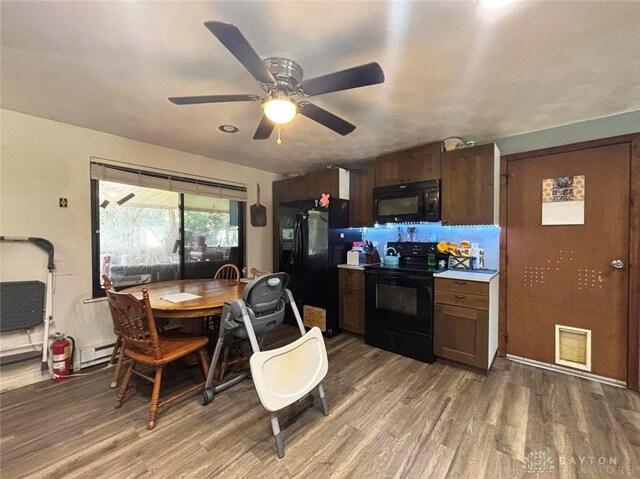 191 Ardmore Dr, Cedarville, OH 45314 - kitchen with black appliances, light wood-type flooring, ceiling fan, light countertops, and dark brown cabinetry