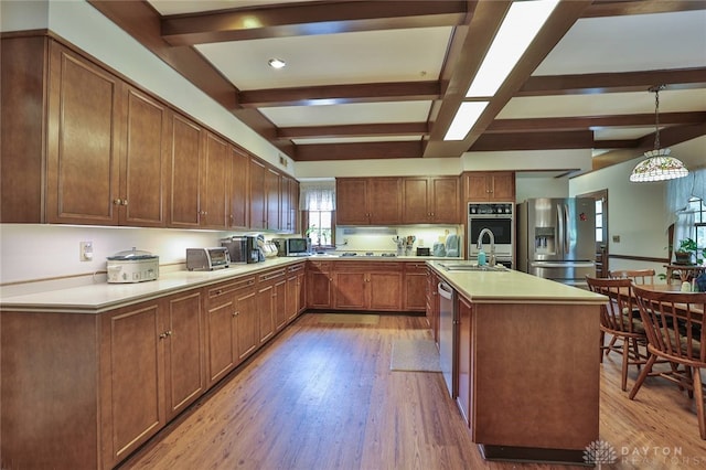 11 Peterson Pl, Wilmington, OH 45177 - kitchen featuring appliances with stainless steel finishes, beamed ceiling, light wood-style floors, light countertops, and pendant lighting
