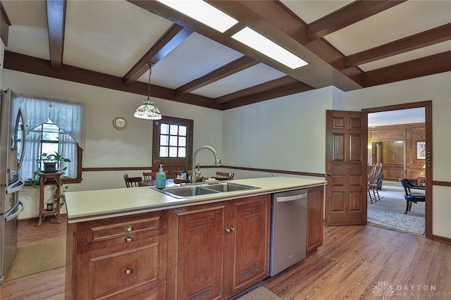 11 Peterson Pl, Wilmington, OH 45177 - kitchen with stainless steel dishwasher, beamed ceiling, light wood finished floors, light countertops, and an island with sink