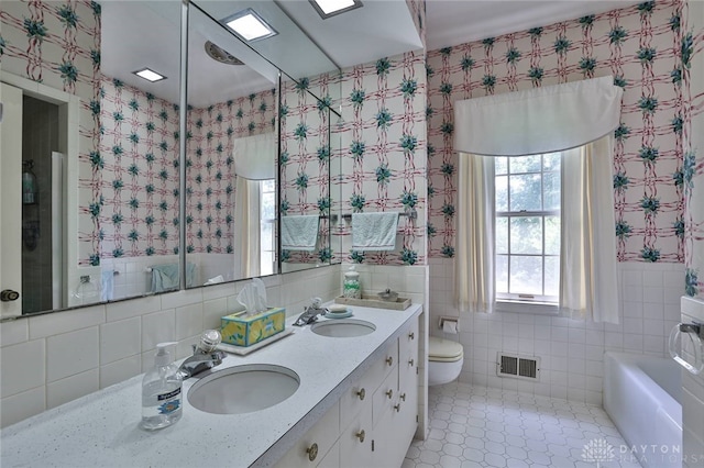 11 Peterson Pl, Wilmington, OH 45177 - bathroom with double vanity, tile walls, and a bath