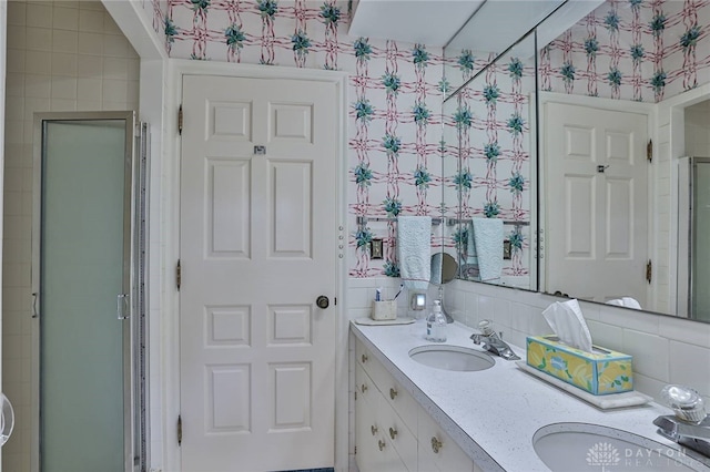 11 Peterson Pl, Wilmington, OH 45177 - full bath with wallpapered walls, double vanity, a shower stall, and decorative backsplash