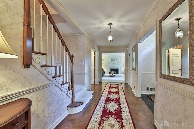 11 Peterson Pl, Wilmington, OH 45177 - entryway featuring wallpapered walls, ornamental molding, stairs, and a fireplace
