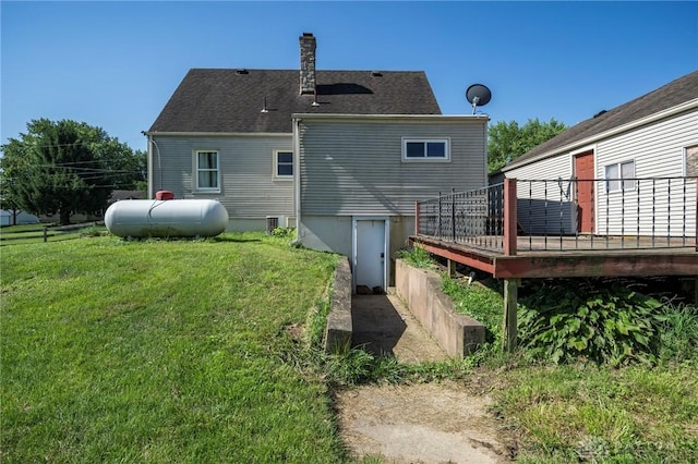 718 Hook Rd, Xenia, OH 45385 - back of property featuring a wooden deck, a lawn, and a chimney