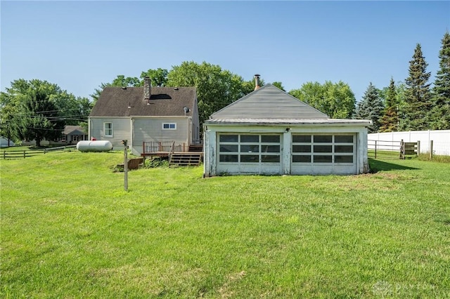718 Hook Rd, Xenia, OH 45385 - rear view of house featuring a detached garage and a deck