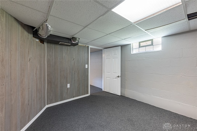 607 Alexander Dr, Dayton, OH 45403 - below grade area with a drop ceiling, carpet, and wooden walls