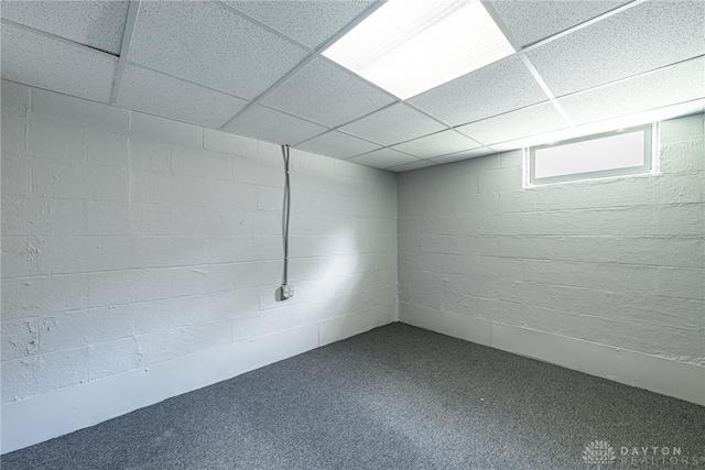 607 Alexander Dr, Dayton, OH 45403 - below grade area with a drop ceiling, dark colored carpet, and concrete block wall