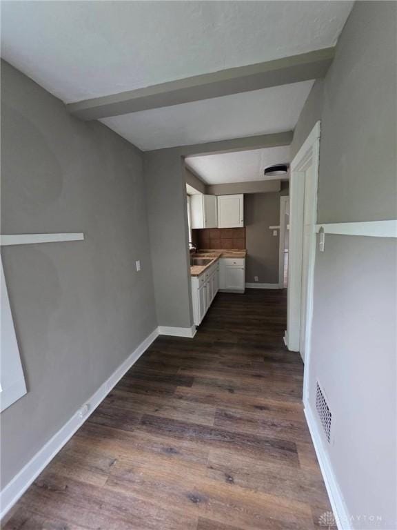 2324 Eastview Unit 2322, Dayton, OH 45405 - kitchen with white cabinetry, dark wood-style flooring, and beamed ceiling