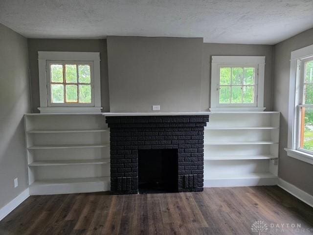 2324 Eastview Unit 2322, Dayton, OH 45405 - unfurnished living room with wood finished floors, a textured ceiling, plenty of natural light, and a fireplace