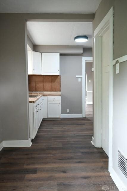 2324 Eastview Unit 2322, Dayton, OH 45405 - kitchen featuring white cabinets, decorative backsplash, dark wood finished floors, and light countertops