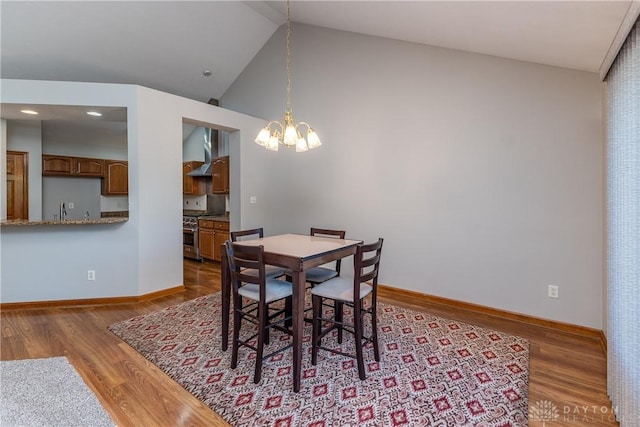 7135 Salem Crossing Pl, Englewood, OH 45322 - dining space featuring a chandelier, wood finished floors, and lofted ceiling