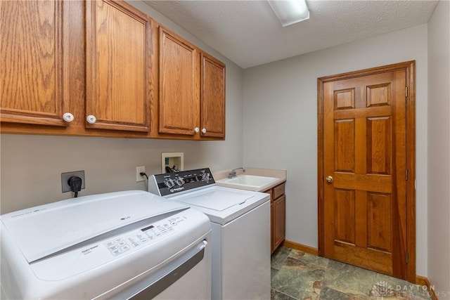 7135 Salem Crossing Pl, Englewood, OH 45322 - washroom featuring separate washer and dryer, cabinet space, and stone finish floors