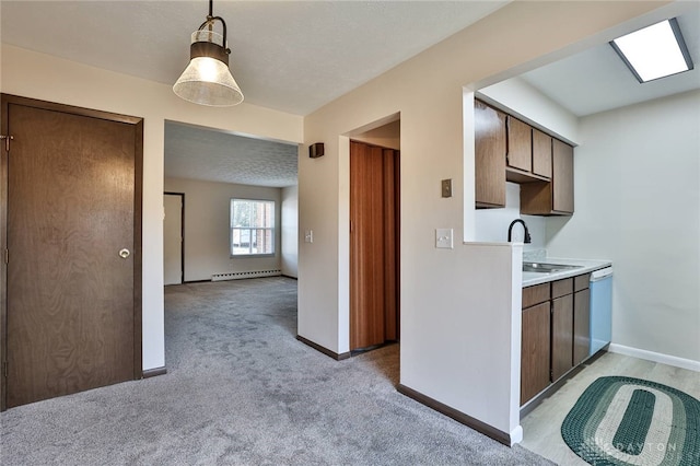 4530 Shawnray Dr Unit 84, Middletown, OH 45044 - kitchen featuring baseboard heating, white dishwasher, light countertops, light carpet, and pendant lighting