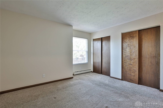 4530 Shawnray Dr Unit 84, Middletown, OH 45044 - unfurnished bedroom with baseboard heating, multiple closets, carpet floors, and a textured ceiling