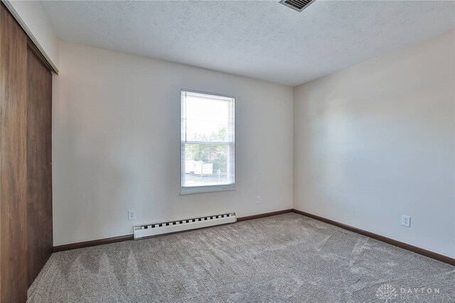 4530 Shawnray Dr Unit 84, Middletown, OH 45044 - unfurnished room featuring baseboard heating, carpet floors, and a textured ceiling