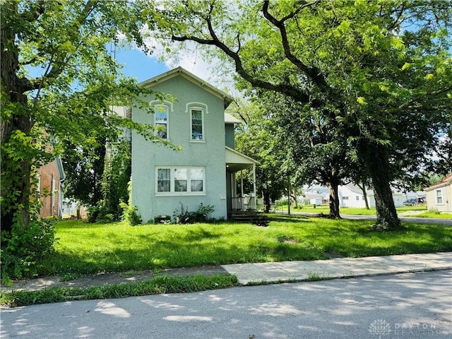 624 E 3rd St, Greenville, OH 45331 - view of front of house with stucco siding and a front yard