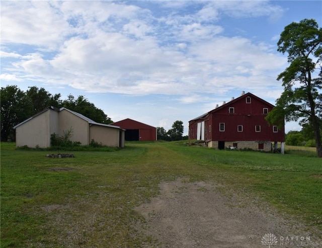 13181 Eaton Pike Unit 13181, New Lebanon, OH 45345 - view of grassy yard featuring dirt driveway, an outbuilding, and a detached garage