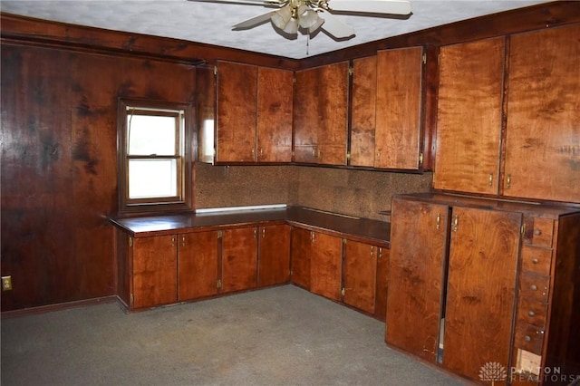 13181 Eaton Pike Unit 13181, New Lebanon, OH 45345 - kitchen with a ceiling fan, brown cabinetry, dark countertops, and decorative backsplash