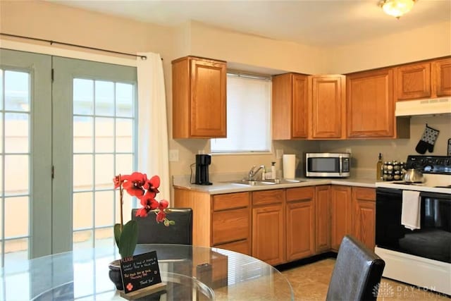 4646 Wayne Meadows Cir Unit 4640, Dayton, OH 45424 - kitchen featuring white electric range, stainless steel microwave, under cabinet range hood, light countertops, and brown cabinetry