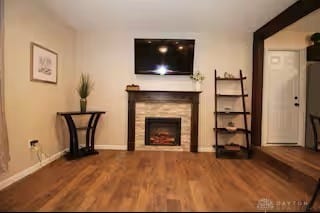 4646 Wayne Meadows Cir Unit 4640, Dayton, OH 45424 - unfurnished living room featuring wood finished floors and a fireplace