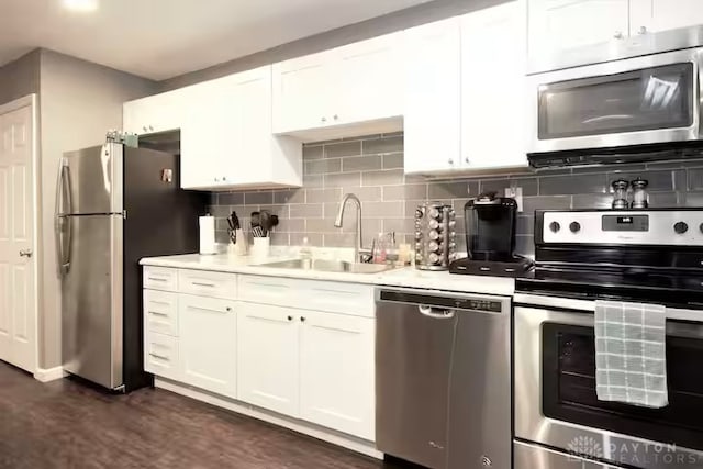 4646 Wayne Meadows Cir Unit 4640, Dayton, OH 45424 - kitchen featuring appliances with stainless steel finishes, light countertops, white cabinets, and backsplash