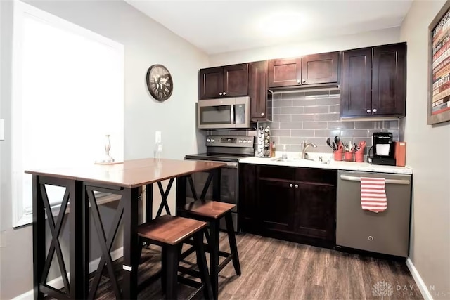 4646 Wayne Meadows Cir Unit 4640, Dayton, OH 45424 - kitchen featuring appliances with stainless steel finishes, backsplash, wood finished floors, dark brown cabinets, and light countertops