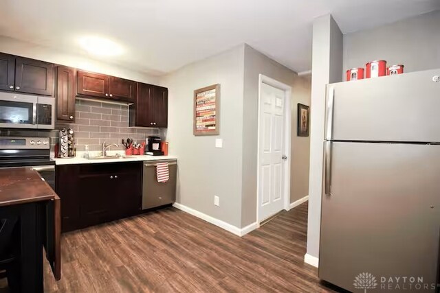 4646 Wayne Meadows Cir Unit 4640, Dayton, OH 45424 - kitchen featuring appliances with stainless steel finishes, tasteful backsplash, dark wood finished floors, dark brown cabinetry, and light countertops