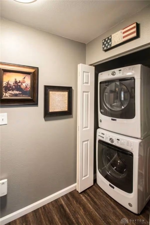 4646 Wayne Meadows Cir Unit 4640, Dayton, OH 45424 - washroom with stacked washing machine and dryer and dark wood-style flooring