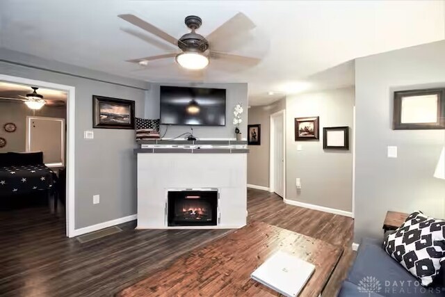 4646 Wayne Meadows Cir Unit 4640, Dayton, OH 45424 - living room with ceiling fan, dark wood-style floors, and a warm lit fireplace