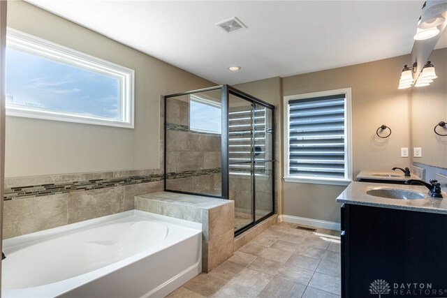 225 Woodstream Dr, Springboro, OH 45066 - full bath featuring a bath, double vanity, a shower stall, tile patterned floors, and recessed lighting