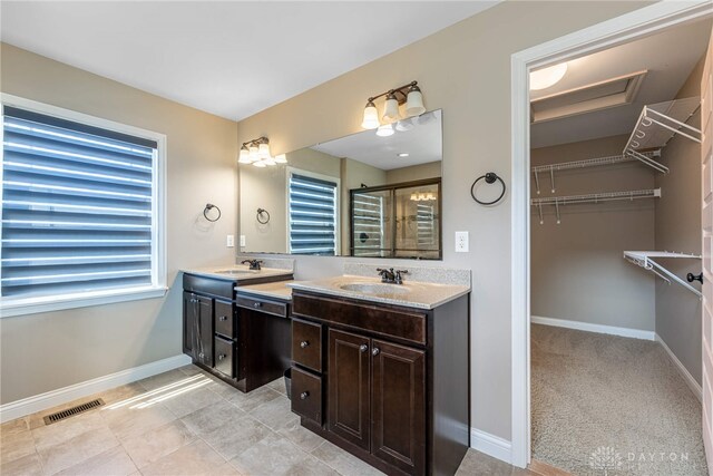 225 Woodstream Dr, Springboro, OH 45066 - bathroom with double vanity, a stall shower, a walk in closet, and tile patterned flooring