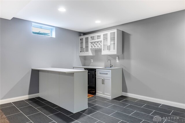 225 Woodstream Dr, Springboro, OH 45066 - kitchen with glass insert cabinets, a peninsula, white cabinetry, recessed lighting, and light countertops