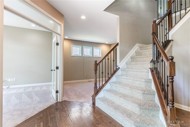 225 Woodstream Dr, Springboro, OH 45066 - stairway featuring wood finished floors, recessed lighting, and carpet floors