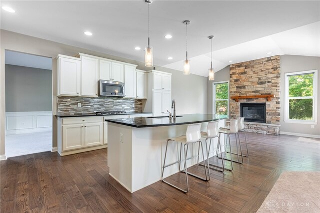 225 Woodstream Dr, Springboro, OH 45066 - kitchen with appliances with stainless steel finishes, dark countertops, healthy amount of natural light, dark wood-type flooring, and lofted ceiling