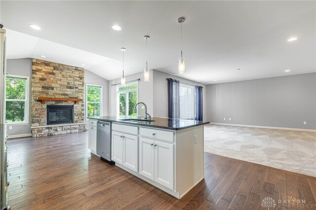 225 Woodstream Dr, Springboro, OH 45066 - kitchen featuring open floor plan, stainless steel dishwasher, dark countertops, vaulted ceiling, and dark wood finished floors