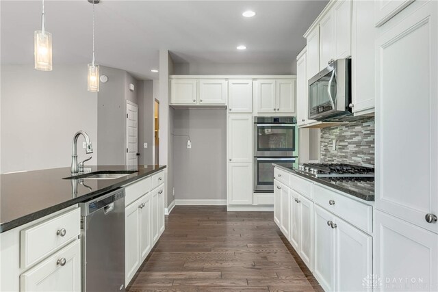 225 Woodstream Dr, Springboro, OH 45066 - kitchen featuring stainless steel appliances, recessed lighting, tasteful backsplash, dark wood-style floors, and white cabinetry