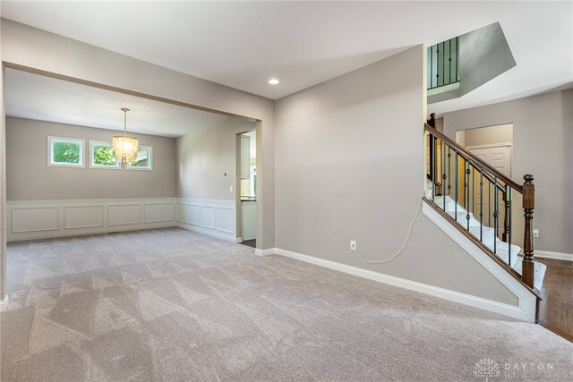 225 Woodstream Dr, Springboro, OH 45066 - carpeted spare room with a chandelier, stairway, wainscoting, recessed lighting, and a decorative wall