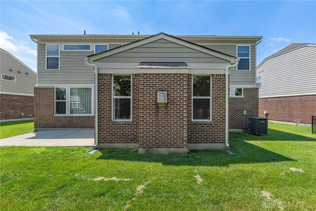 225 Woodstream Dr, Springboro, OH 45066 - rear view of property featuring a lawn, brick siding, and a patio