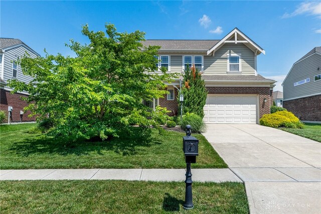 225 Woodstream Dr, Springboro, OH 45066 - view of front of property with brick siding, driveway, an attached garage, and a front yard
