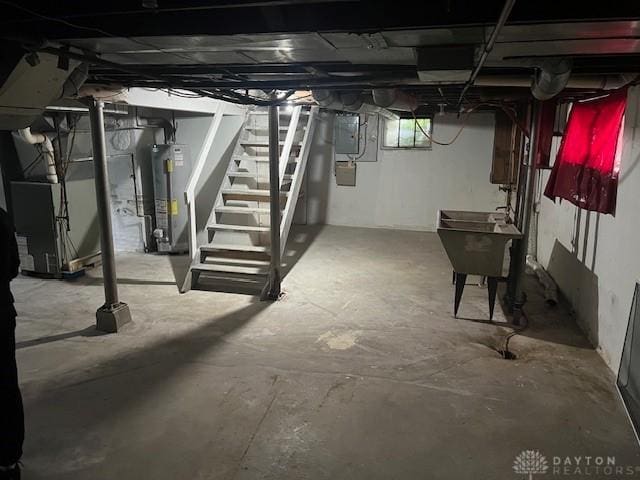 417 Sandalwood Dr, Dayton, OH 45405 - basement featuring electric panel, gas water heater, stairway, and heating unit