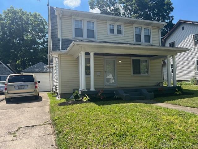 417 Sandalwood Dr, Dayton, OH 45405 - view of front of house with a porch, a front lawn, and a detached garage