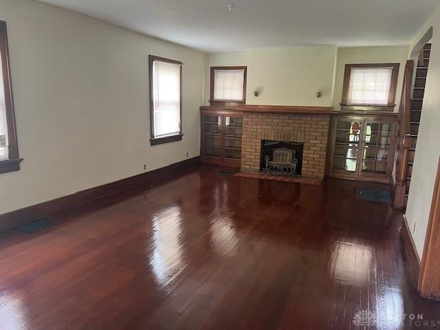 417 Sandalwood Dr, Dayton, OH 45405 - unfurnished living room featuring hardwood / wood-style floors and a brick fireplace