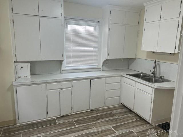 417 Sandalwood Dr, Dayton, OH 45405 - kitchen featuring white cabinets, light countertops, and wood finish floors