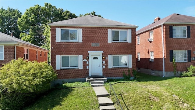 228 E Bruce Ave, Dayton, OH 45405 - view of front facade with a front lawn, brick siding, and cooling unit