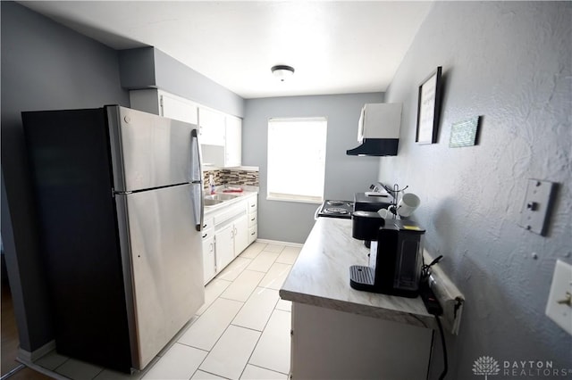 228 E Bruce Ave, Dayton, OH 45405 - kitchen with freestanding refrigerator, range hood, white cabinetry, light countertops, and range with electric stovetop