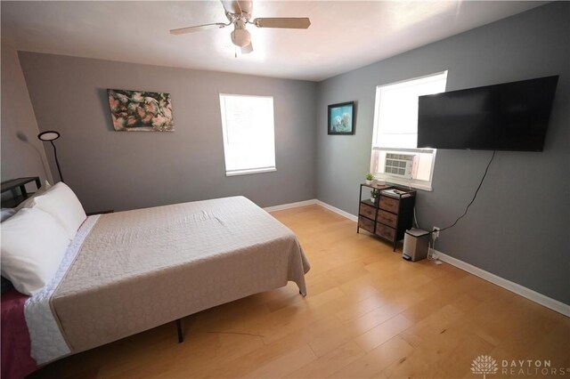 228 E Bruce Ave, Dayton, OH 45405 - bedroom with multiple windows, light wood-style flooring, a ceiling fan, and cooling unit