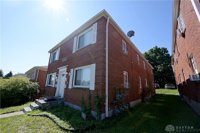 228 E Bruce Ave, Dayton, OH 45405 - view of side of property featuring brick siding and a yard