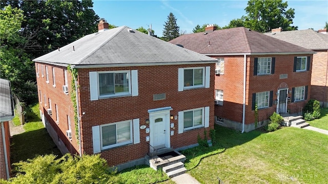 228 E Bruce Ave, Dayton, OH 45405 - view of front of property with brick siding, a shingled roof, a chimney, and a front yard