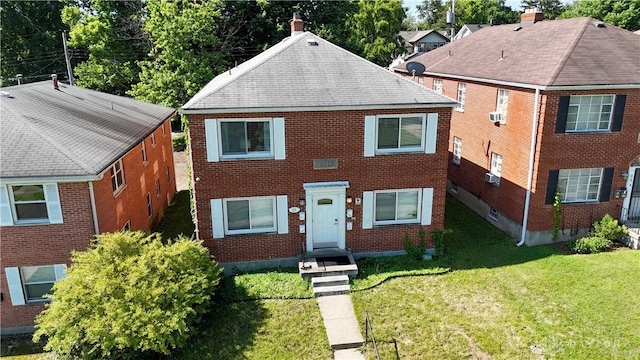 228 E Bruce Ave, Dayton, OH 45405 - view of front facade with a front yard, brick siding, and a shingled roof