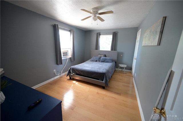 228 E Bruce Ave, Dayton, OH 45405 - bedroom featuring light wood-style flooring, a textured ceiling, a ceiling fan, and cooling unit