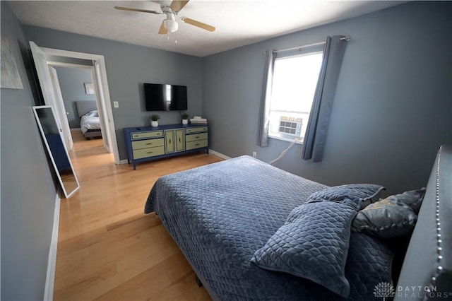 228 E Bruce Ave, Dayton, OH 45405 - bedroom with light wood-type flooring, cooling unit, and ceiling fan